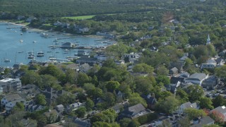 AX144_144 - 5.5K stock footage aerial video orbiting small coastal town, boats, Edgartown, Martha's Vineyard, Massachusetts