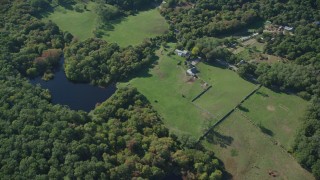 AX144_157 - 5.5K stock footage aerial video of a bird's eye view, rural homes, ponds, West Tisbury, Martha's Vineyard, Massachusetts