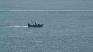 AX144_167 - 5.5K aerial stock footage tracking a fishing boat on the Atlantic Ocean