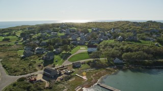 AX144_171E - 5.5K aerial stock footage approaching a coastal community, Cuttyhunk Island, Elisabeth Islands, Massachusetts