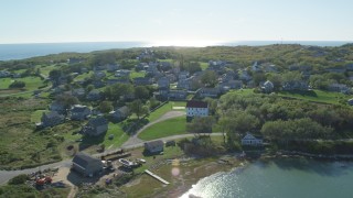 AX144_173 - 5.5K aerial stock footage flying by coastal community, Cuttyhunk Island, Elisabeth Islands, Massachusetts
