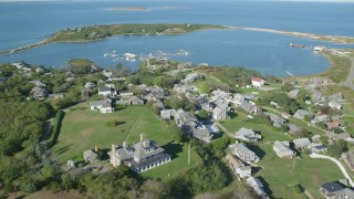 AX144_176 - 5.5K aerial stock footage of a coastal community near pond, Cuttyhunk Island, Elisabeth Islands, Massachusetts