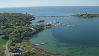 AX144_177 - 5.5K aerial stock footage of a coastal community near pond, Cuttyhunk Island, Elisabeth Islands, Massachusetts