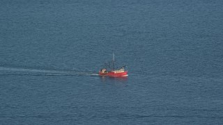 AX144_181E - 6k aerial stock footage tracking a fishing boat on the Atlantic Ocean