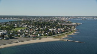 AX144_187E - 6k aerial stock footage flying by coastal community, factory, New Bedford, Massachusetts
