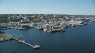 AX144_193 - 6k aerial stock footage of a pier, fishing boats, coastal community, factories, New Bedford, Massachusetts