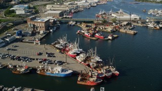 AX144_195 - 6k aerial stock footage tilting down, fly over over piers, fishing boats, New Bedford, Massachusetts