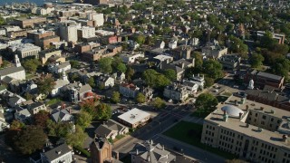 AX144_200E - 6k aerial stock footage flying by buildings, Trinity United Methodist Church, New Bedford, Massachusetts