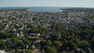 AX144_202E - 6k aerial stock footage approaching coastal community, New Bedford, Massachusetts