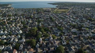 AX144_204 - 6k aerial stock footage flying by coastal community, New Bedford, Massachusetts
