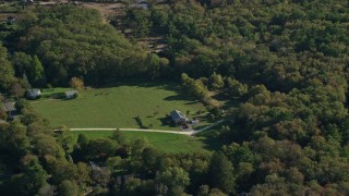 AX144_214 - 6k aerial stock footage flying by rural homes, lawns, trees, Dartmouth, Massachusetts