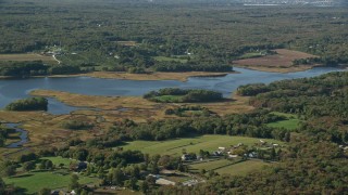 AX144_215 - 6k aerial stock footage flying by river and marshland, Westport, Massachusetts