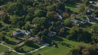 AX144_217E - 6k aerial stock footage flying by rural homes near a river, Little Compton, Rhode Island