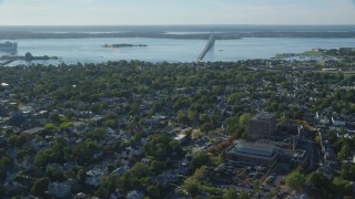 AX144_228 - 6k aerial stock footage flying over coastal community, approach Newport Bridge, Newport, Rhode Island