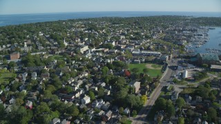 AX144_230 - 6k aerial stock footage flying by coastal community, baseball field, Newport, Rhode Island