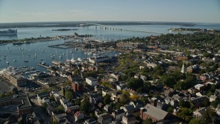 AX144_234E - 6k aerial stock footage orbiting coastal community, Newport Harbor, Newport, Rhode Island
