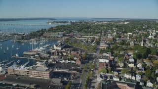 AX144_235 - 6k stock footage aerial video orbiting coastal community, Newport Harbor, Newport, Rhode Island