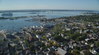 AX144_236 - 6k stock footage aerial video orbiting coastal community, busy Newport Harbor, Newport, Rhode Island