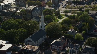 AX144_237 - 6k stock footage aerial video orbiting Trinity Church, quiet neighborhood, Newport, Rhode Island