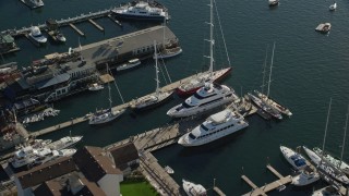AX144_238 - 6k stock footage aerial video approaching piers, tilt to bird's eye view over boats, Newport, Rhode Island