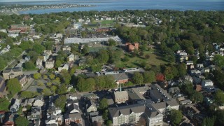 AX144_240 - 6k stock footage aerial video flying by strip mall, tennis courts, Edward King House, Newport, Rhode Island