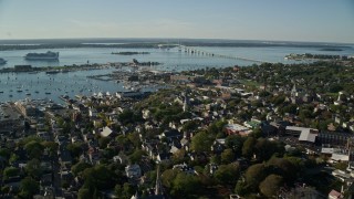 AX144_244 - 6k stock footage aerial video flying by coastal community, Newport Harbor, Newport, Rhode Island