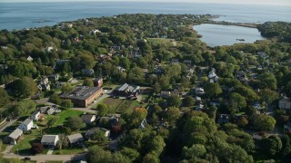 AX144_246 - 6k aerial stock footage flying over coastal community, approach Almy Pond, Newport, Rhode Island