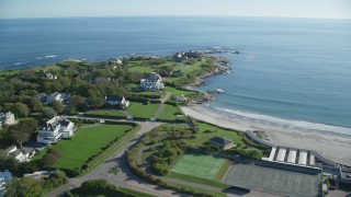 AX144_249 - 6k aerial stock footage flying over coastal community, oceanfront mansion, Newport, Rhode Island