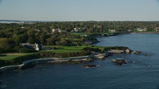 AX144_254 - 6k aerial stock footage flying by oceanfront mansion, green lawns, Newport, Rhode Island