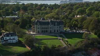 AX144_258 - 6k aerial stock footage flying by Ochre Court, oceanfront mansion, Newport, Rhode Island