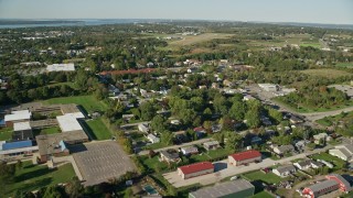 AX144_262E - 6k aerial stock footage flying over neighborhoods, Middletown High School toward airport, Middletown, Rhode Island