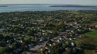 AX145_001E - 6k aerial stock footage flying by a coastal community, Middletown, Rhode Island