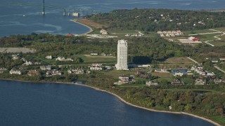 AX145_008 - 6k aerial stock footage flying by upscale waterfront homes, condominium complex, Portsmouth, Rhode Island