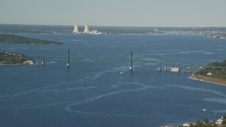 AX145_009E - 6k aerial stock footage flying by Mount Hope Bridge, Dynegy Brayton Point, Portsmouth, Rhode Island
