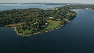 AX145_012 - 6k aerial stock footage flying by waterfront mansions, green lawns, trees, Bristol, Rhode Island