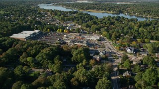 AX145_019E - 6k aerial stock footage flying over County Road, approaching strip mall, Barrington, Rhode Island