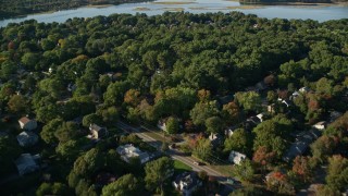 AX145_021E - 6k aerial stock footage flying over suburban neighborhoods, large trees, Barrington, Rhode Island