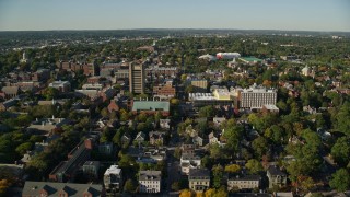 AX145_070E - 6k aerial stock footage approaching Brown University, colorful trees, Providence, Rhode Island