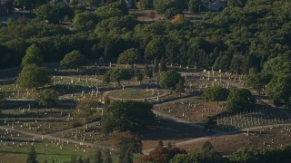 AX145_092 - 6k aerial stock footage flying by a cemetery, green trees, Providence, Rhode Island