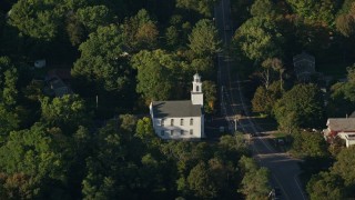 AX145_100 - 6k aerial stock footage flying by First Congregational Church, tilt down, North Attleborough, Massachusetts