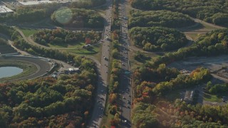 AX145_107 - 6k aerial stock footage flying by Interstate 495, autumn, Plainville, Massachusetts