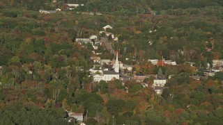 AX145_108E - 6k aerial stock footage flying by small town and church, autumn, Foxborough, Massachusetts
