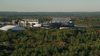AX145_114E - 6k aerial stock footage flying low, approaching Gillette Stadium, autumn, Foxborough, Massachusetts