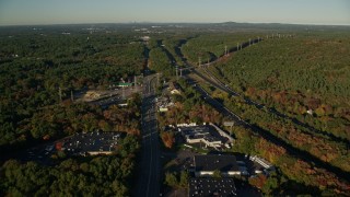 AX145_123E - 6k aerial stock footage of Boston Providence Highway, warehouses, Interstate 95, Walpole, Massachusetts