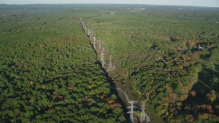 AX145_126 - 6k stock footage aerial video flying by decision forest, power lines, autumn, Walpole, Massachusetts