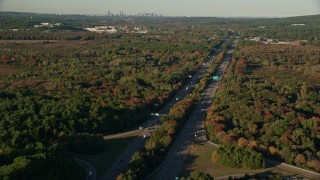 AX145_128E - 6k aerial stock footage flying by Interstate 95, colorful trees, autumn, Norwood, Massachusetts