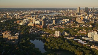 AX146_012 - 6k aerial stock footage of Longwood Medical Area, reveal skyline, Downtown Boston, Massachusetts, sunset