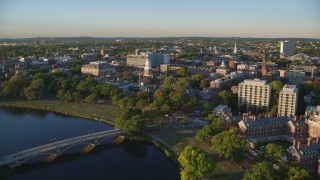 AX146_019 - 6k stock footage aerial video flying over Chalres River, approach Harvard University, Massachusetts, sunset