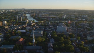 AX146_023 - 6k aerial stock footage flying by Harvard University, Cambridge, Massachusetts, sunset