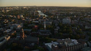 AX146_035E - 6k aerial stock footage flying by Harvard University, Cambridge, Massachusetts, sunset
